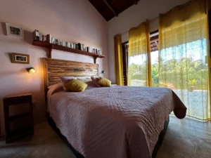 A cozy bedroom with a spacious double bed, adorned with comfortable furnishings and inviting decor.