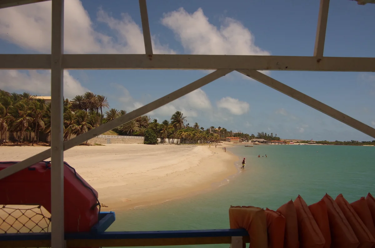 A captivating view from a boat, overlooking the vast expanse of the ocean meeting a pristine beach, creating a serene and picturesque seascape.