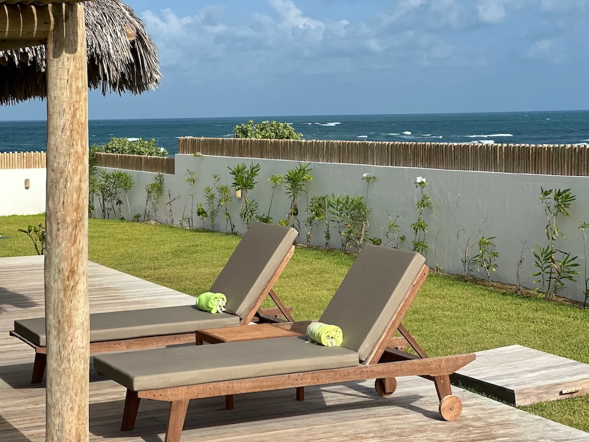 Sunbeds arranged with a scenic view, offering a relaxing place to soak up the sun while enjoying a beautiful landscape.