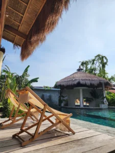 Soak up the sun in paradise: Relaxing poolside on comfortable sunbeds at a Siargao resort, surrounded by lush greenery.