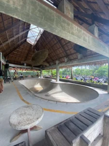 A skate park bowl in Siargao, Philippines, with skaters performing tricks. One of the exciting activities to do in Siargao.