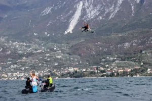 Kitesurfer jumping over a boat