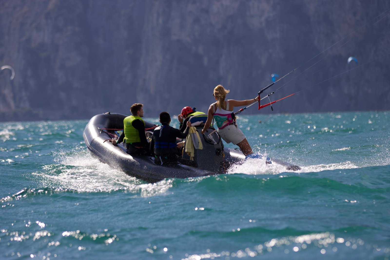 kitesurf instructor from kitevoyage giving a lesson in Lake Garda Italy. Beautiful full lake in the middle of the mountain  