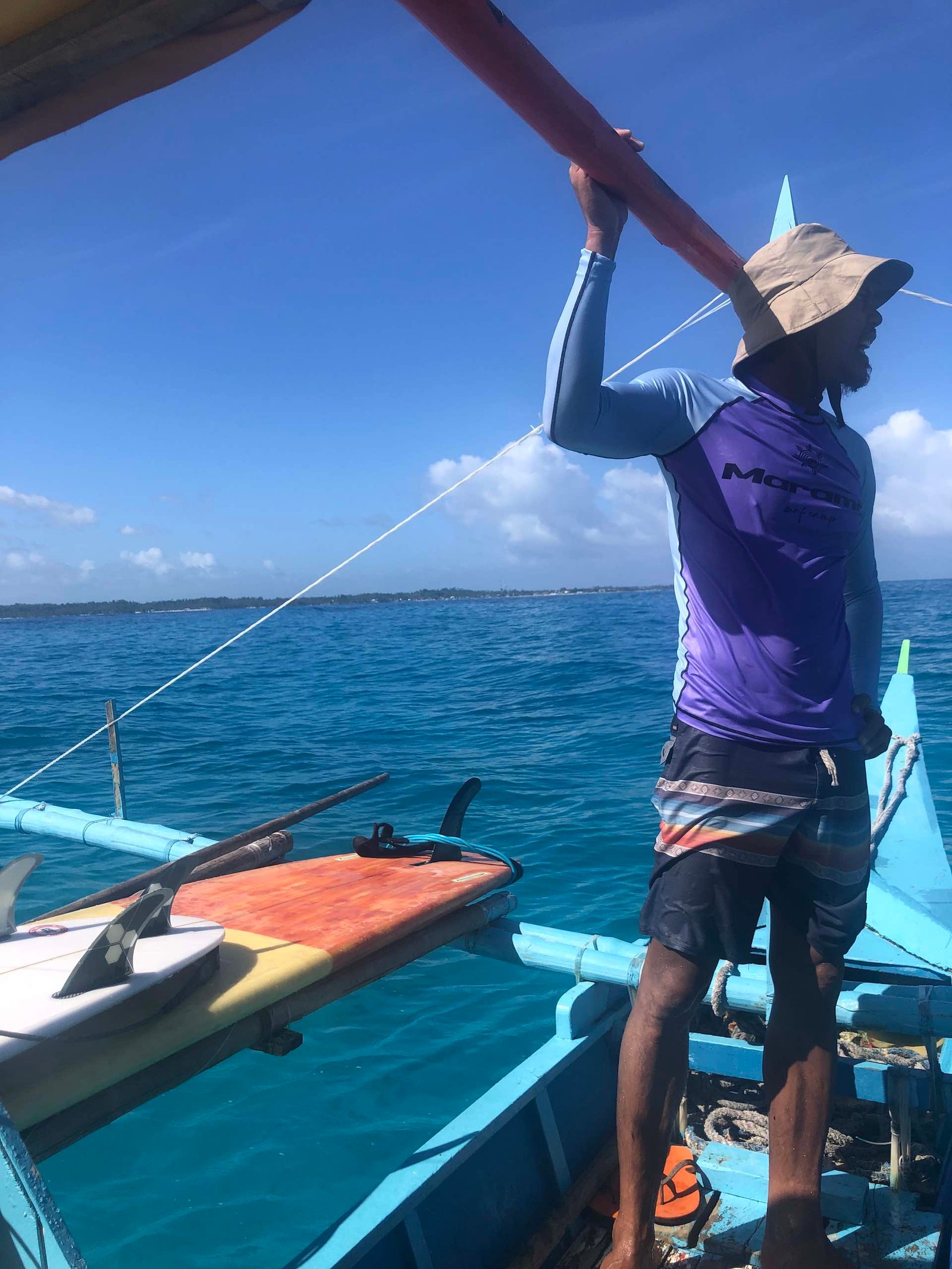 Surf instructor from marama surf school, in Siargao  Philippines bringing student on a beautiful spot with a boat during the kitesurf camp of kite voyage