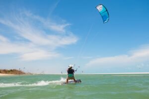 kitesurf girl from kitevoyage kitecamp riding in the lagoon in brazil with the perfect condition