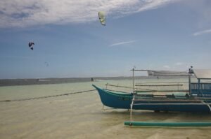 kitesurfer enjoying the ride in the lagoon of General Luna Siargao Philippines. with a beautifull sun and turquoise water