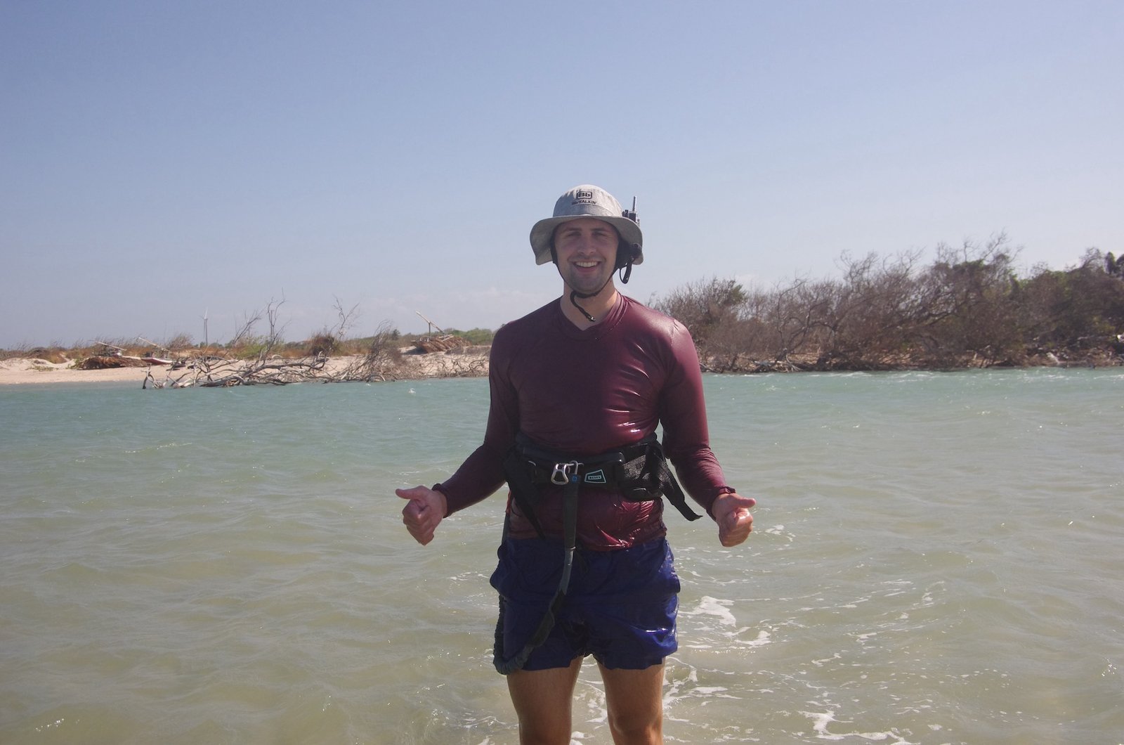 protrait of student smiling and standing in a lagoon of brazil during a kitesurfing camp with kitevoyage