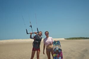 Marie and a student together during a kitesurf lesson in Brazil with Kitevoyage kitecamp in a empty spot with the perfect condiotn for kitesurfing and wingfoiling