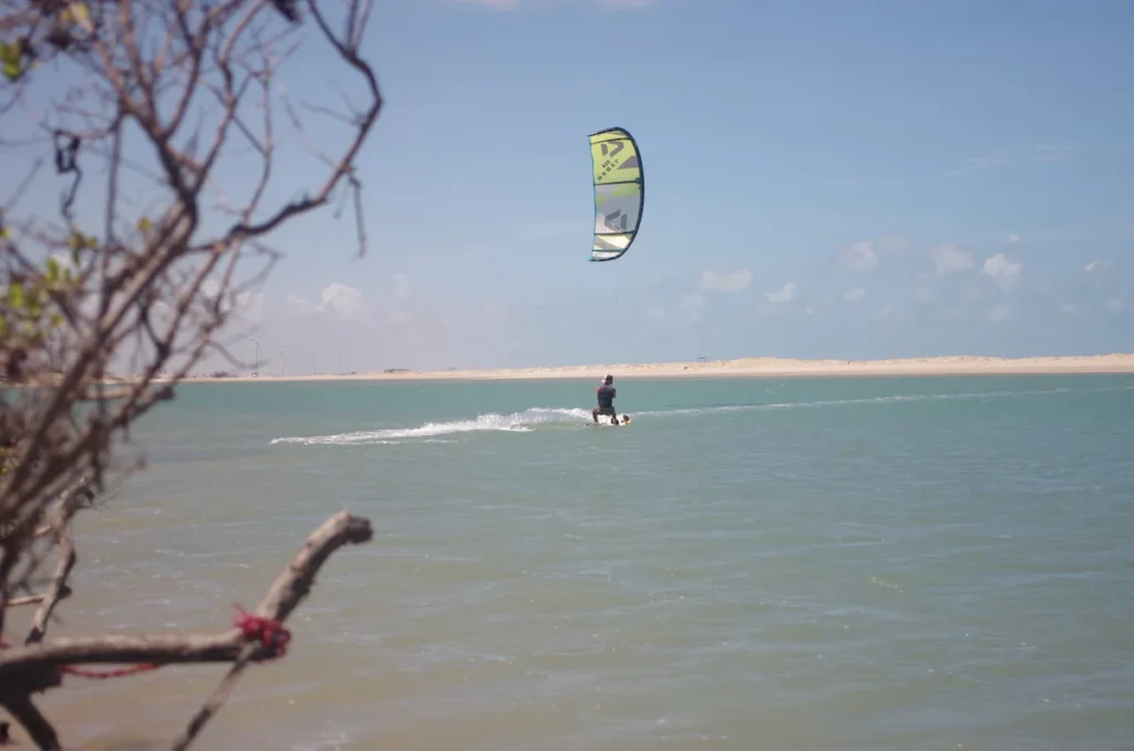 Kitesurfer enjoying the waters of Parajuru Kitesurf Lagoon, capturing the thrilling essence of the sport against the scenic backdrop of the lagoon in Brazil.